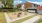 sand filled square with fire pit and lawn chairs adjacent to mail boxes